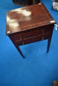 A late 19th or early 20th Century mahogany work table with line inlay decoration, lift lid and