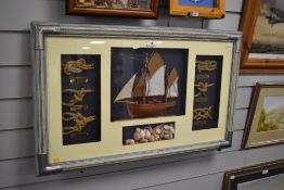 A decorative nautical themed box frame display, with small central half model boat, knot examples