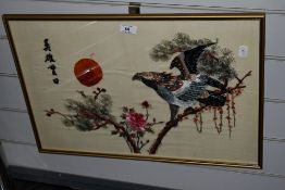 A vintage Oriental embroidery on silk depicting a perched Eagle and blossoms, framed and glazed 38.