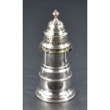 A George V silver sugar sifter, of traditional design with pierced finial topped twist-off cover