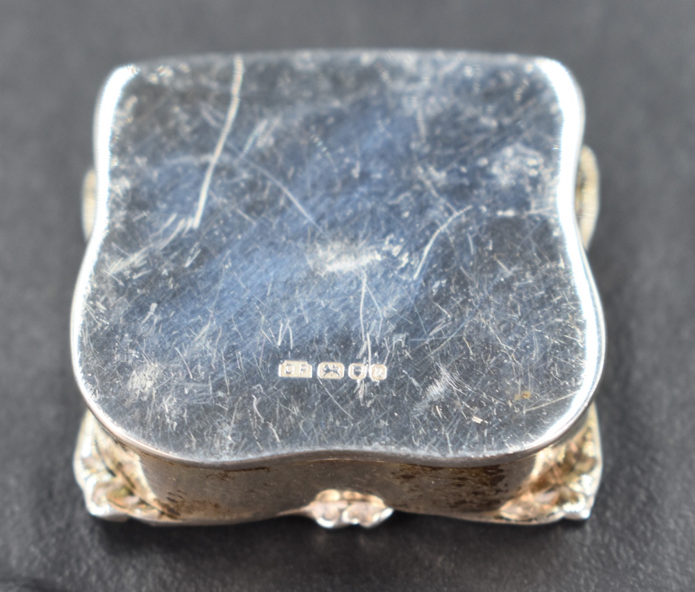 A Queen Elizabeth II silver pill box, of small proportions and of hinged and shaped square form, the - Image 2 of 2