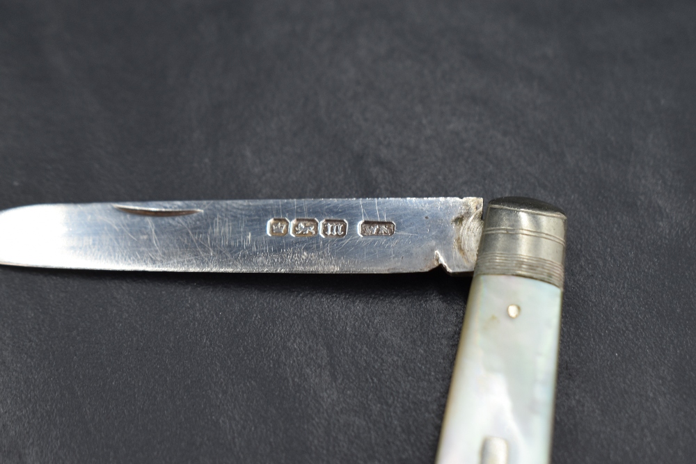 A silver bladed fruit knife having a mother-of-pearl handle and decorative edge, with marks for - Image 2 of 3