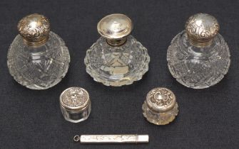 Three silver mounted cut glass scent bottles of various size, age and design, all having embossed