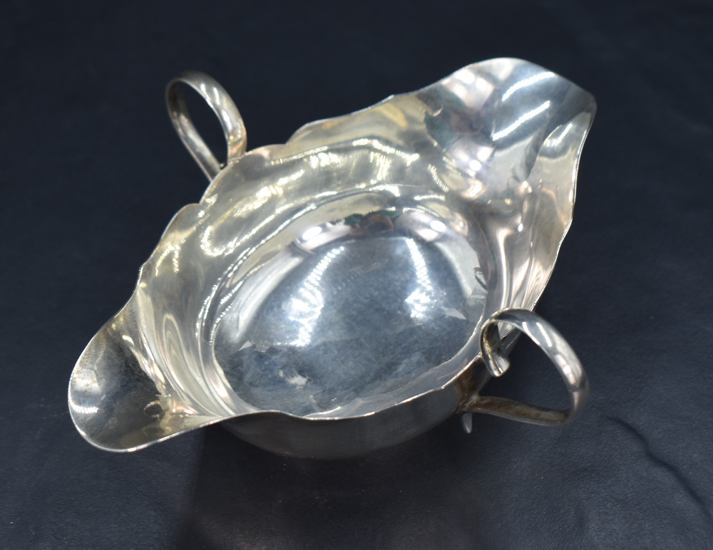 A George V silver double spouted and handled sauce boat, having a shaped rim and applied loop - Image 3 of 4