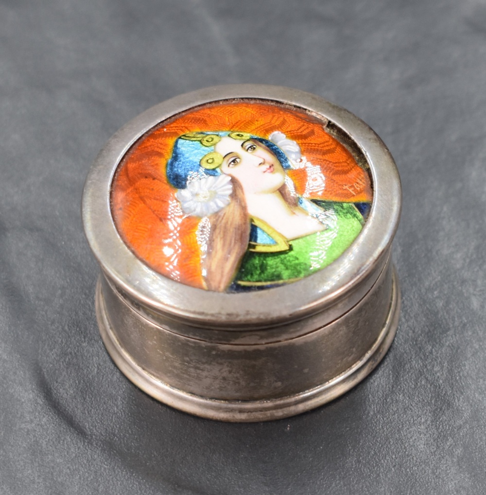 An Edwardian circular silver and enamel box, the hinged cover having a slightly domed circular