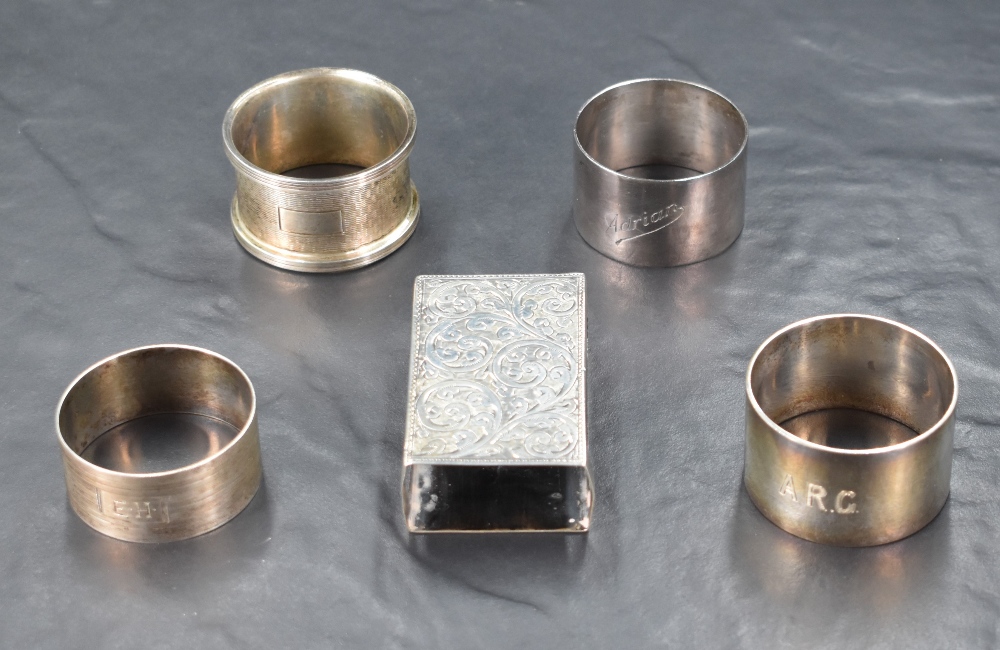 A group of four mixed hallmarked silver napkin rings, various age and manufacturers, sold along with