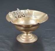 A small Continental white metal pedestal dish, having crimped and rolled rim, the booge ornamented