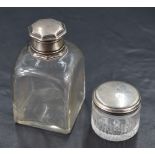 A George III silver topped glass dressing table jar, of moulded circular form with remains of