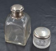 A George III silver topped glass dressing table jar, of moulded circular form with remains of