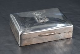 A George V silver cigarette box, of hinged rectangular form the cover embossed with a Crown