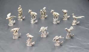 An interesting set of twelve Italian 800 grade white metal place card/setting holders, formed as