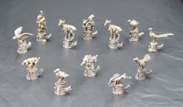 An interesting set of twelve Italian 800 grade white metal place card/setting holders, formed as