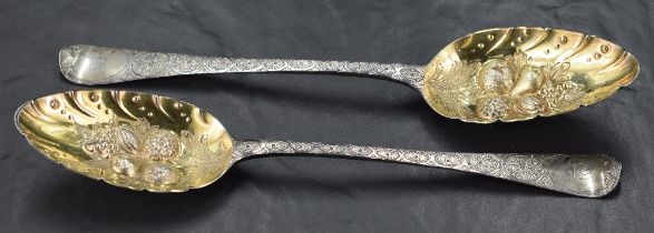 Two George III silver 'Berry' spoons, Old English pattern with later embossed and engraved