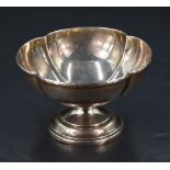 A George V silver bowl, of lobed circular form with short spreading stem and step moulded circular