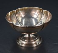 A George V silver bowl, of lobed circular form with short spreading stem and step moulded circular
