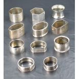 A group of eleven silver napkin rings, various shapes, age, makers and design, gross lot weight