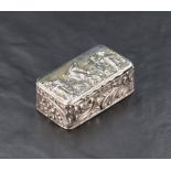 A late Victorian silver box, of hinged rectangular form, the cover embossed with musician and dancer