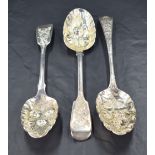 Three 19th century silver berry spoons, two in the fiddle pattern having marks for London 1828,