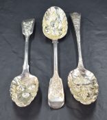 Three 19th century silver berry spoons, two in the fiddle pattern having marks for London 1828,