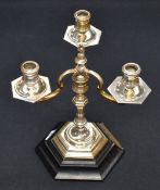 An impressive early Queen Elizabeth II silver three-branch candlestick, of turned and hexagonal