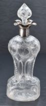 A George V silver mounted moulded and engraved glass 'Glug-Glug' decanter, having a foliate engraved