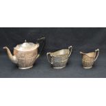 A George V silver three-piece tea set, comprising teapot, sugar and cream, each of oval half-