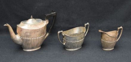 A George V silver three-piece tea set, comprising teapot, sugar and cream, each of oval half-