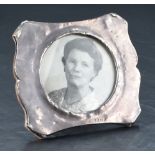 A George V silver mounted wooden photograph frame, of a curved rectangular form, with marks for