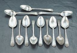Two sets of six George III silver bright-cut Old English pattern teaspoons, the first engraved