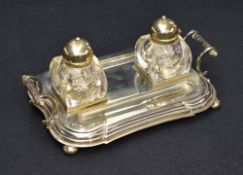 An early 20th century silver-plated inkstand, of shaped and step-moulded rectangular form with