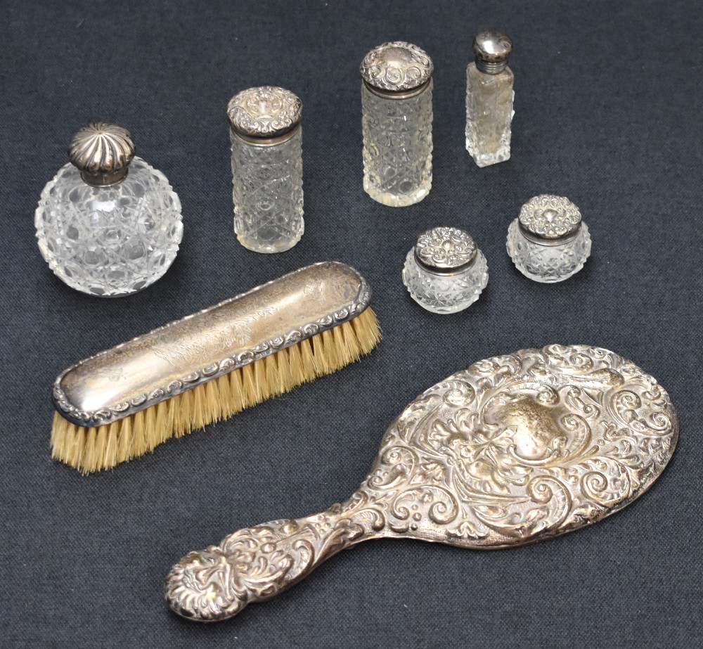 A selection late 19th and early 20th century silver mounted dressing table wares, including four cut