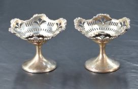 A pair of George V silver pedestal bon bon dishes, of shaped and dished circular form with