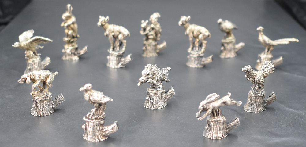 An interesting set of twelve Italian 800 grade white metal place card/setting holders, formed as - Image 3 of 4