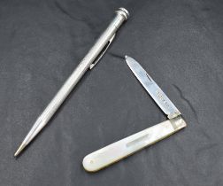 A silver bladed fruit knife having a mother-of-pearl handle and decorative edge, with marks for