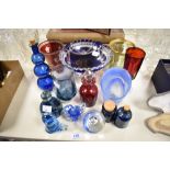 A selection of art glass, including blue hued cut glass tazza, paperweights, ruby glass vase with