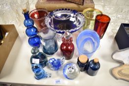 A selection of art glass, including blue hued cut glass tazza, paperweights, ruby glass vase with