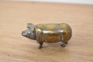 A novelty white metal vesta case, in the form of a pig, with hinged head, measuring 5cm long