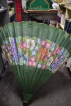 An oriental style parasol, decorated with a foliate design on green