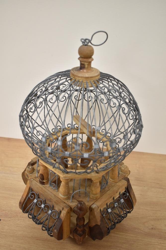 A 20th Century African wrought iron and wooden bird cage, of balloon shape, measuring 32cm tall - Image 2 of 2