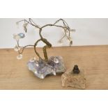 A novelty solid brass lucky pixie pipe tamper set within a quartz rock together with a wire gemstone