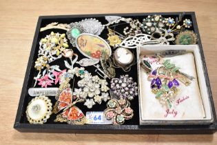 A collection of costume brooches of various designs including paste set Edwardian style bar
