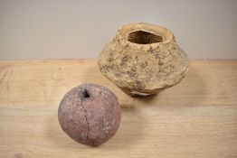 A medieval cannon ball, diameter 8cm, and a terracotta coloured pot