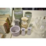 A collection of studio pottery, having matte finishes in lilacs, greens a beige.