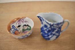 A 19th Century blue and white porcelain miniature jug, measuring 5cm, and a Chinese polychrome