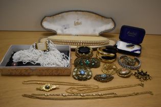 An assortment of costume jewellery including faux gold pearls, a multi-strand beaded necklace and