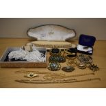 An assortment of costume jewellery including faux gold pearls, a multi-strand beaded necklace and