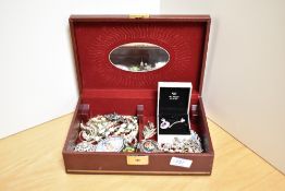 A faux leather jewellery box containing an assortment of costume jewellery including a Warren