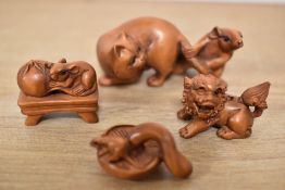 A group of carved boxwood netsukes and models, one in the form of a cat and mouse, having incised