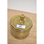 A Victorian brass lidded candy jar, of circular form, measuring 11cm tall