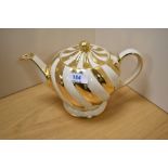 A cream and gold Sadler teapot.